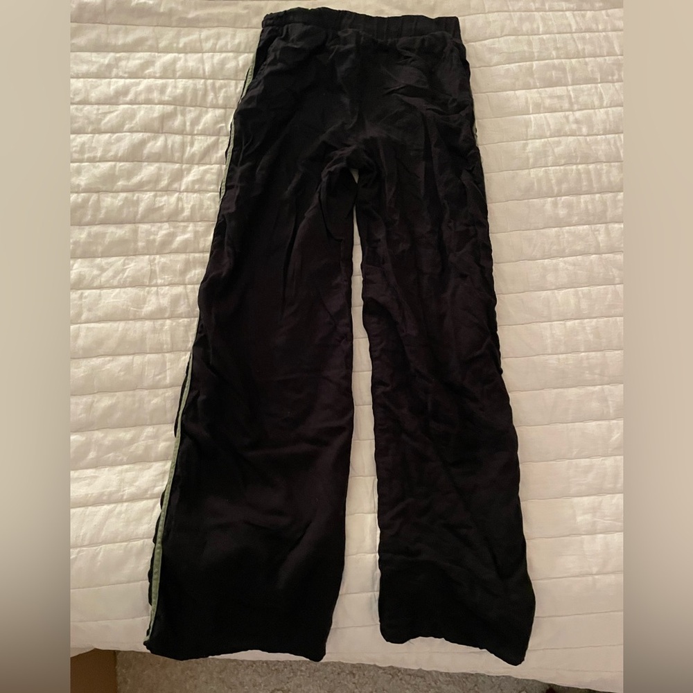 Black straight leg pants with green stripes on sides